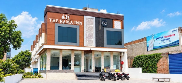 A hotel named 'The Rama Inn' with a modern facade, large windows, and a visible entrance. - The Rama Inn (Faizabad)