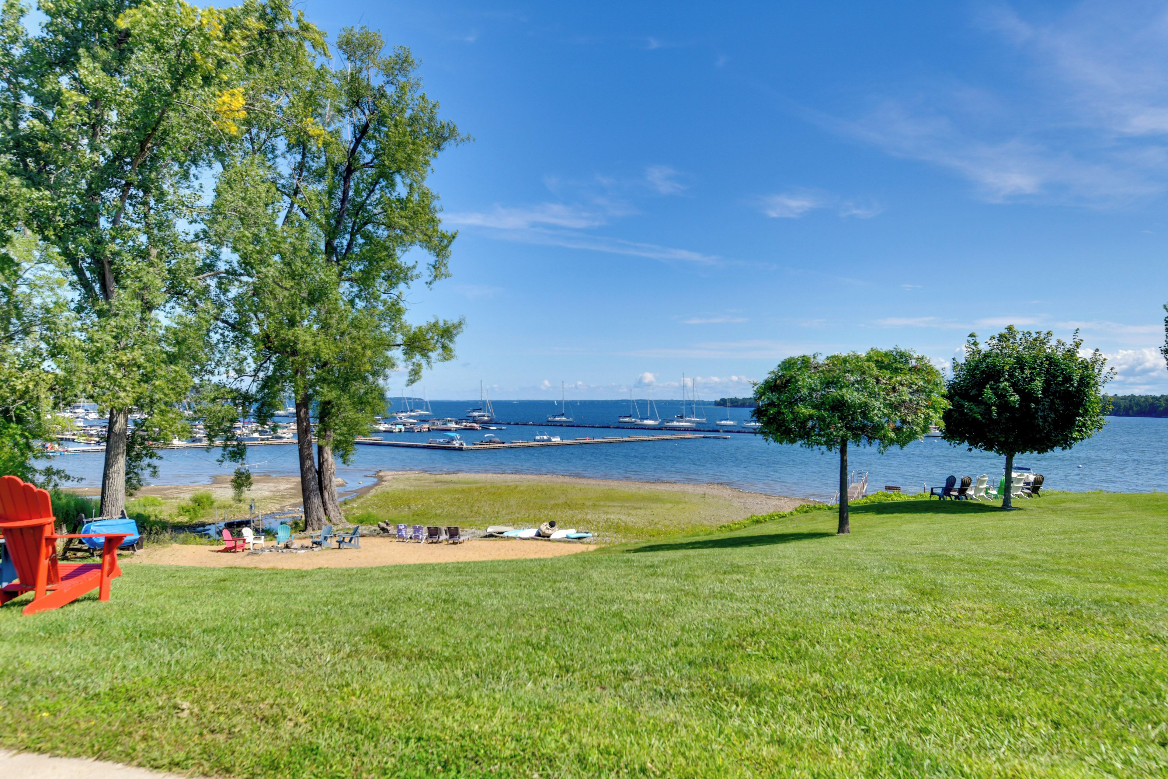 A grassy area with a clear view of a marina and boats.
