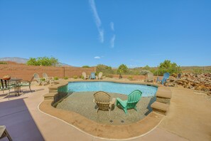 A swimming pool with a stone border, surrounded by outdoor furniture and a clear sky. - Hike & Unwind! Studio w/ Pool & Hot Tub Access (Washington)