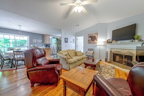 A spacious living room with a fireplace, leather furniture, and a television. - Ski & Hike! Cozy Sapphire Retreat (Sapphire)