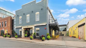 A two-story building with a restaurant named 'Chadwick's Restaurant' on the ground floor. There are outdoor seating areas with tables and chairs.