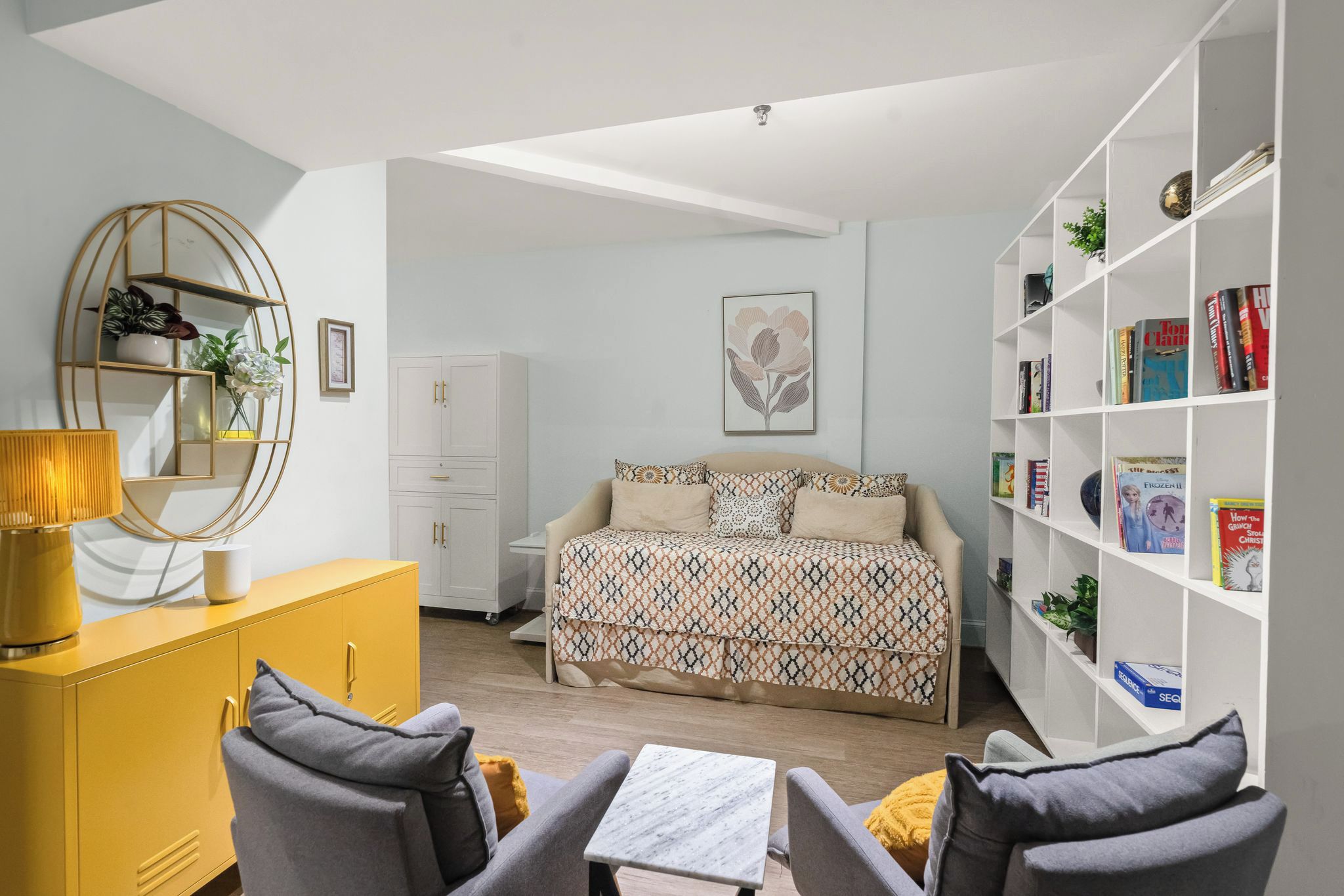 A bedroom with a bed, bedside tables, a wardrobe, a bookshelf, and a desk.