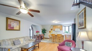 A living room with a sofa, a coffee table, and a dining area with chairs and a table. - 6 Mi to Dtwn! Historic Haven in Cleveland (Cleveland)