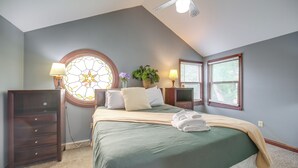 A bedroom with a bed, a dresser, a nightstand, a lamp, a window, and a ceiling fan. - 6 Mi to Dtwn! Historic Haven in Cleveland (Cleveland)