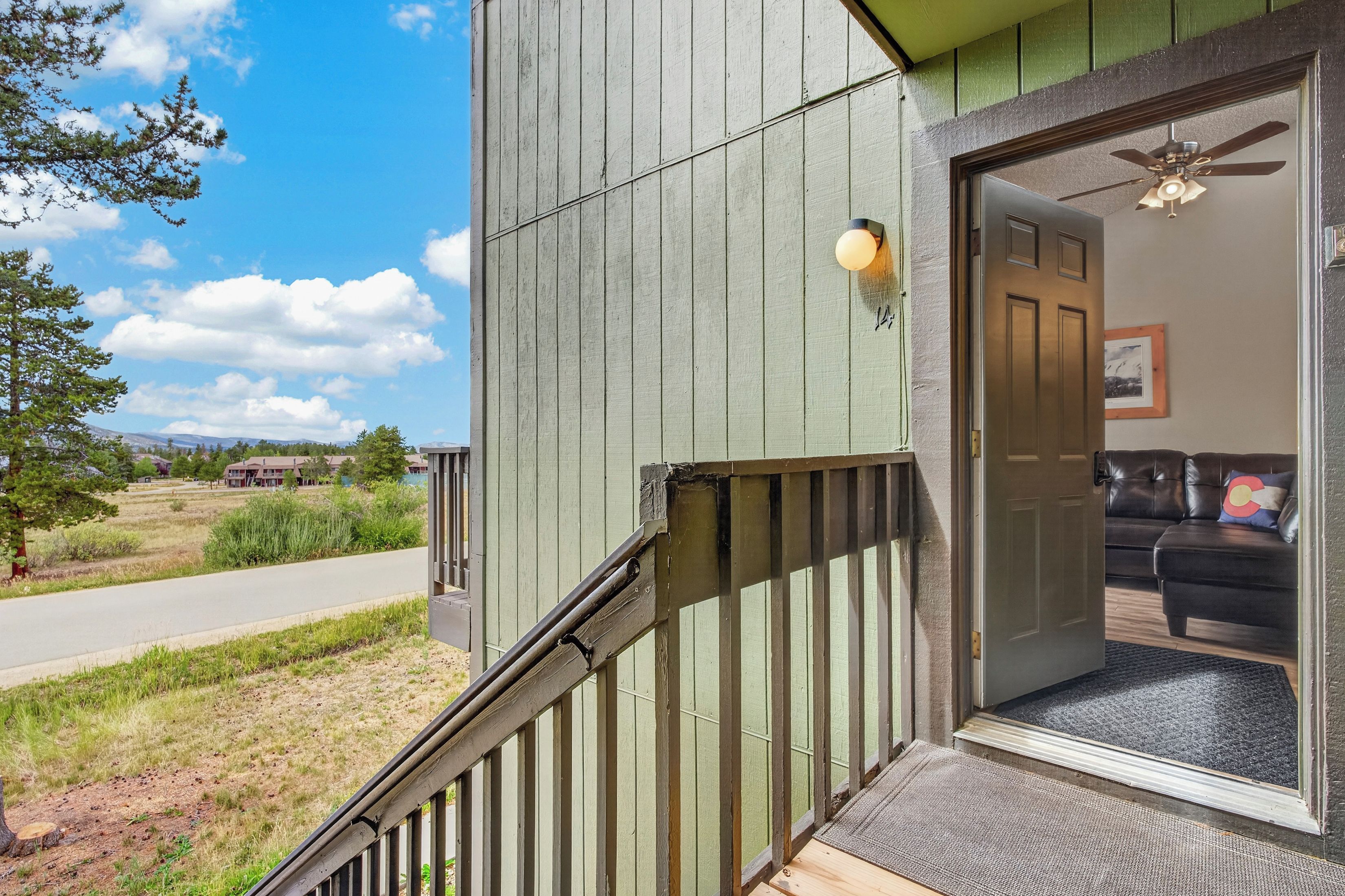 A residential property with a visible entrance, a porch, and a view of the surrounding landscape.