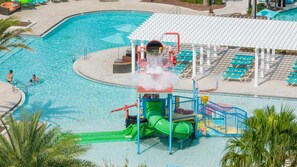A swimming pool with a water slide, lounge chairs, and a covered seating area. - Family Dream Home Pool Arcade Slide Bed 2472 (Kissimmee)