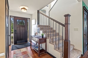 A staircase with a wooden handrail and carpeted steps, leading to an upper floor. - Winter Lakeside Lodge on Lake Winter | Hot Tub | Trail Access | Dog Friendly (Winter)