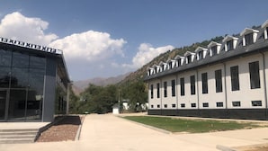 A modern building with a glass facade and a series of windows on the right side. - Oxygen garden (Yangiabad)