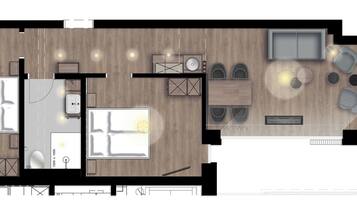 A hotel room layout with a bed, bedside table, and a small seating area.