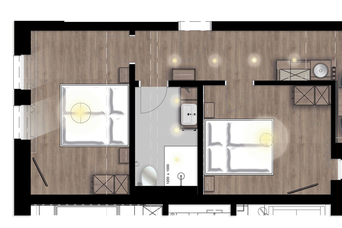 A floor plan of a hotel room with a bed, a desk, a chair, a small bathroom, and a seating area with a table and chairs.