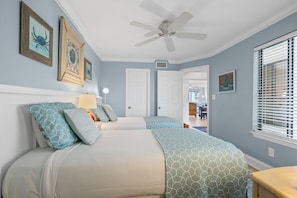 A bedroom with two beds, a ceiling fan, and artwork on the walls. - Heron Walk 8986 Golf Cart, Pool, Sleeps 6 (Miramar Beach)