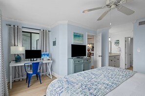 A bedroom with a bed, desk, chair, TV, and a ceiling fan. - Heron Walk 8986 Golf Cart, Pool, Sleeps 6 (Miramar Beach)