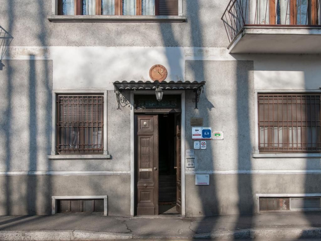 A building facade with a door, windows, and a clock.