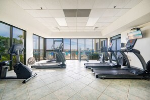 A gym with multiple treadmills, exercise bikes, and a fan. - Phoenix Vi 6804 2 Bedroom Condo (Orange Beach)