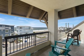 A balcony with a view of the beach and ocean, wooden railings, and two Adirondack chairs. - The Club at Mexico Beach, panoramic gulf views, steps to the beach, community po (Mexico Beach)