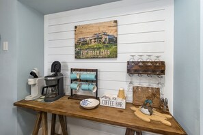 A coffee bar setup with a coffee maker, mugs, and a sign reading 'COFFEE BAR'. - The Club at Mexico Beach, panoramic gulf views, steps to the beach, community po (Mexico Beach)