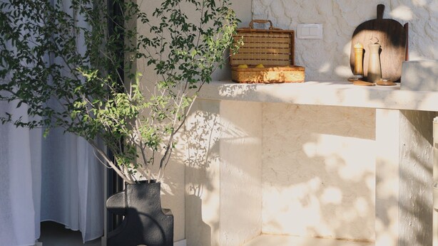 A room with a large window, a hanging basket, a wooden chest, and a stone wall. - Casa Casolare by The Residence (Šibenik)
