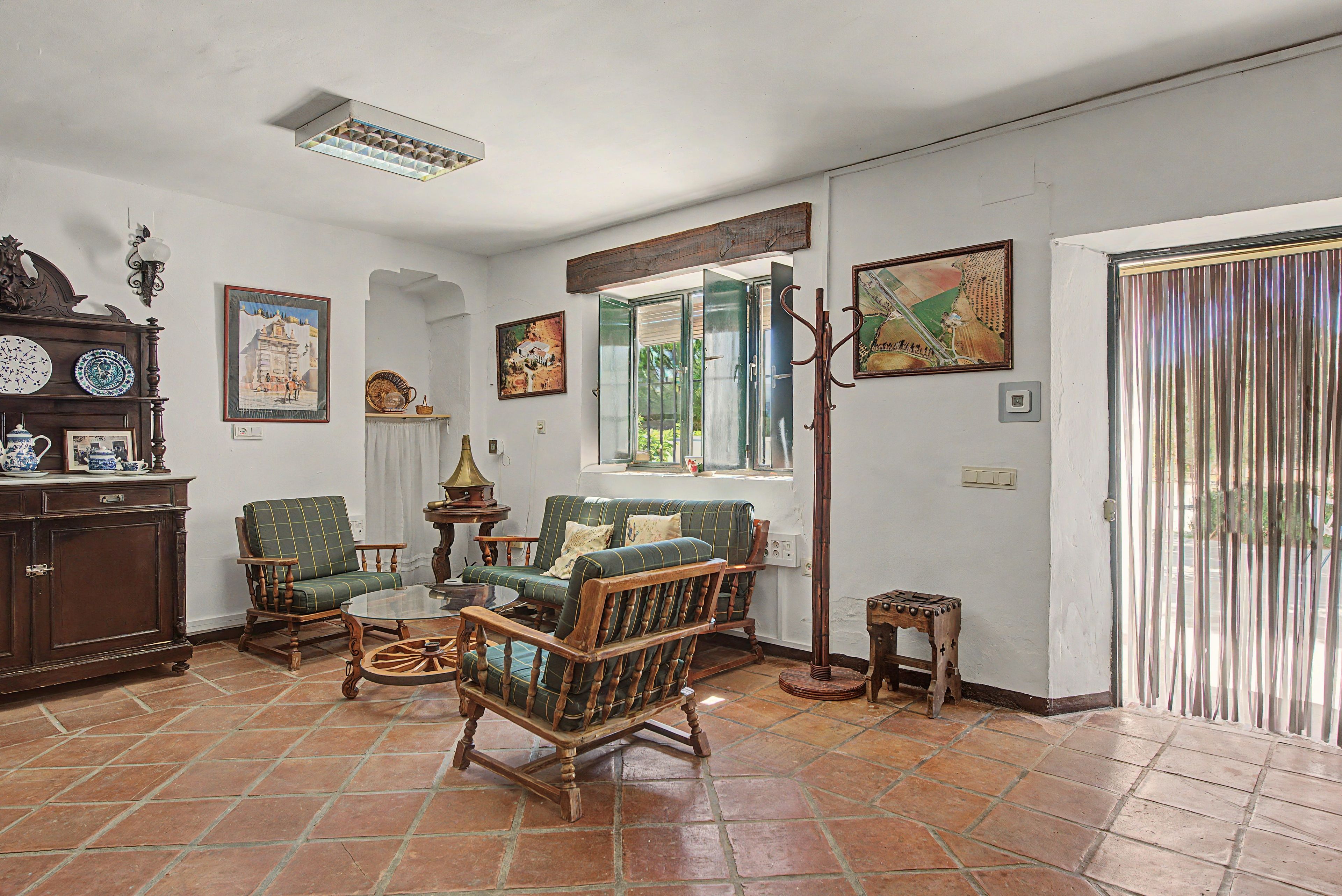 A traditional living room with a fireplace, a dining table, and a sofa.