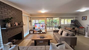 A living room with a fireplace, a television, and a sofa.
