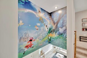 A bathroom with a large mural featuring animated characters and a castle. - Reunion Village 4BR Mickey and Moana Retreat (Kissimmee)