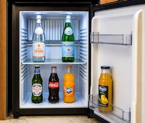 A refrigerator with multiple shelves containing various beverages. - Casa Rubinacci (Napoli)