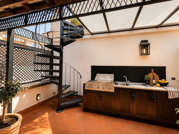A compact kitchen with a gas stove, sink, and wooden cabinets.