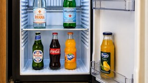 A refrigerator with multiple shelves containing various beverages. - Casa Rubinacci (Napoli)