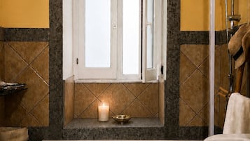 A bathroom with a bathtub, a shower, a toilet, and a sink.