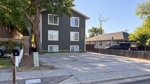 A residential building with a grey facade, numbered 3434, and a driveway leading to a parked vehicle. - 3BR Modern Retreat | Hot Tub | Near 4 Ski Resorts (South Salt Lake)