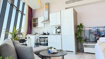 A modern living room with a sofa, coffee table, and a TV.