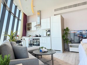 A modern living room with a sofa, coffee table, and a TV.
