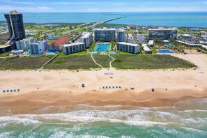 A coastal resort with beachfront properties, a marina, and a large swimming pool. - Saida Royale, Beachfront 10th Floor, 2BR, 3 Pools (South Padre Island)