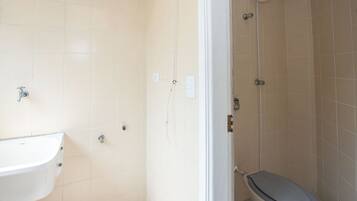 A bathroom with a sink, toilet, and shower.