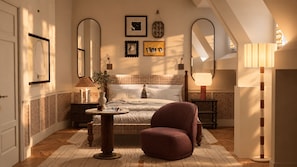A bedroom with a bed, a chair, a bedside table, a lamp, and wall art. - Maison Limelette (Ottignies-Louvain-la-Neuve)