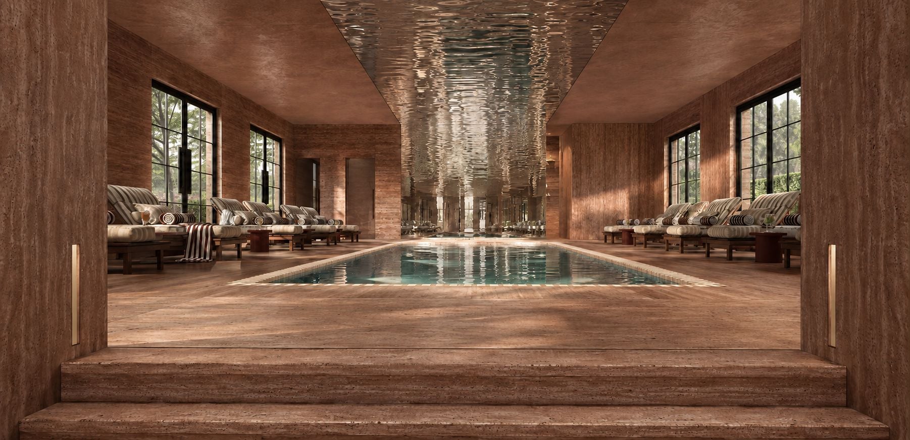 A long, narrow indoor pool with a clear view of the sky through large windows, surrounded by seating areas with cushioned chairs.