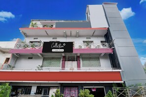 A multi-story building with a prominent sign for 'Collection' on the second floor.