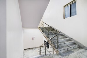 A staircase with metal railings leading to a landing.