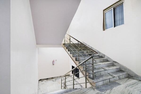 A staircase with metal railings leading to a landing.