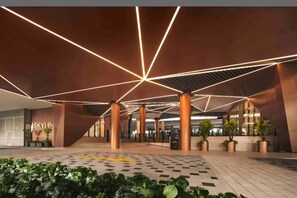 A modern building entrance with geometric ceiling lighting, a central staircase, and potted plants. - Skyline A43A-07 Heart of the city, new (Kuala Lumpur)