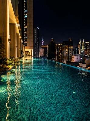 A nighttime swimming pool with city skyline views, surrounded by modern buildings. - Skyline A43A-07 Heart of the city, new (Kuala Lumpur)