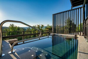 A swimming pool with a metal deck and railing, surrounded by a wooden fence and a clear view of a mountainous landscape. - Romantic Luxe Oasis•Private Pool•Mtn Views•Theater (Pigeon Forge)