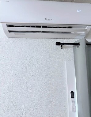 A white Daikiki air conditioner unit with a control panel on the right side.
