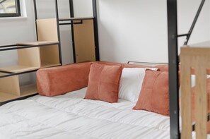 A bed with a white comforter and two pillows, a wooden headboard, and a metal frame. - 10min Hard Rock - Studio, Patio, Workspace (Miami Gardens)