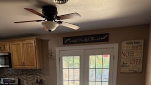 A kitchen with wooden cabinets, a microwave, and a dining table with chairs. - 4-bedroom estate with AC in lovely Enid (Enid)