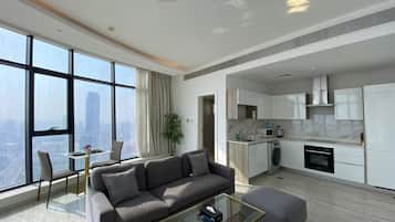A modern apartment with a living room, dining area, and kitchen.