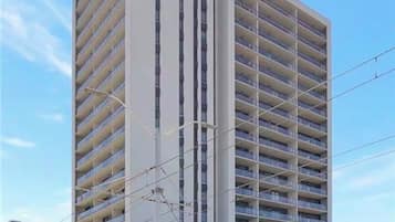A multi-story building with a modern architectural design, featuring a series of balconies on each floor.
