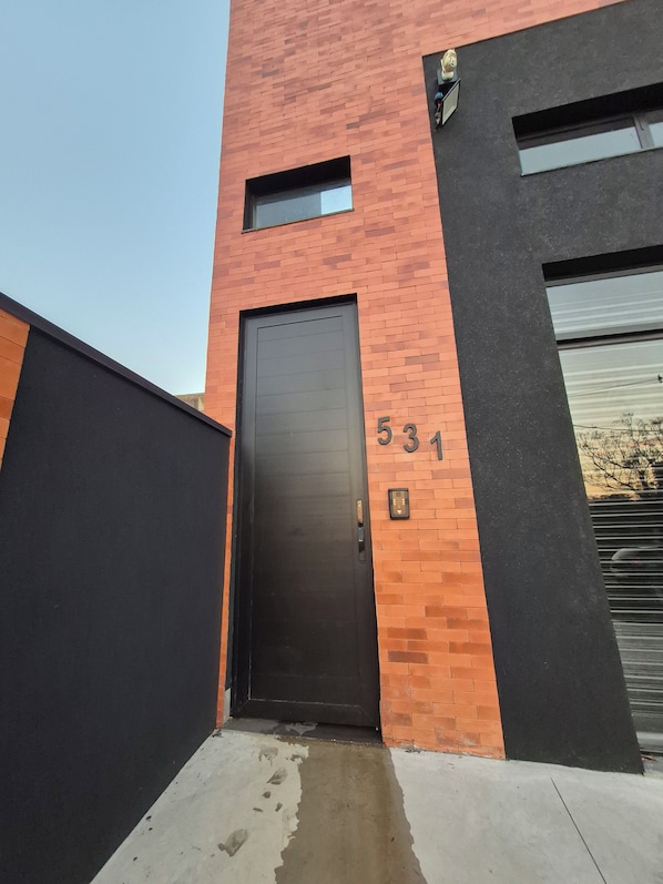 A building with a black door, a number '534' on the wall, and a small window above the door.
