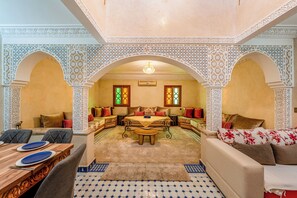 A traditional interior with a sofa set, a dining table, and a patterned floor. - Dar Azur (Swimming Pool & Moroccan Charm) (marakech)