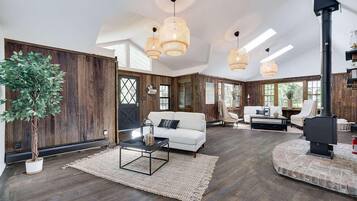 A spacious living area with a white sofa, a coffee table, and a fireplace.