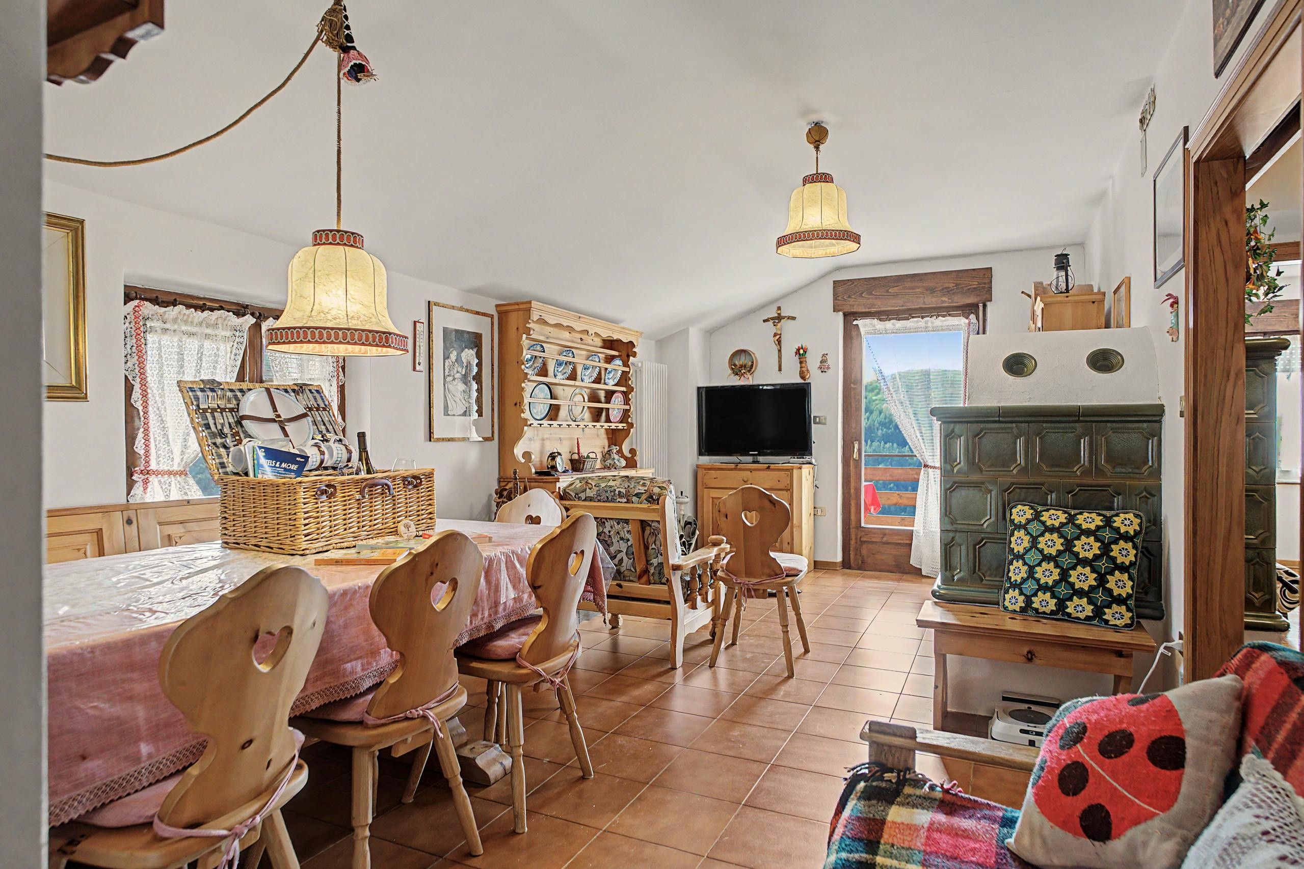 A cozy living room with a television, wooden furniture, and a fireplace.